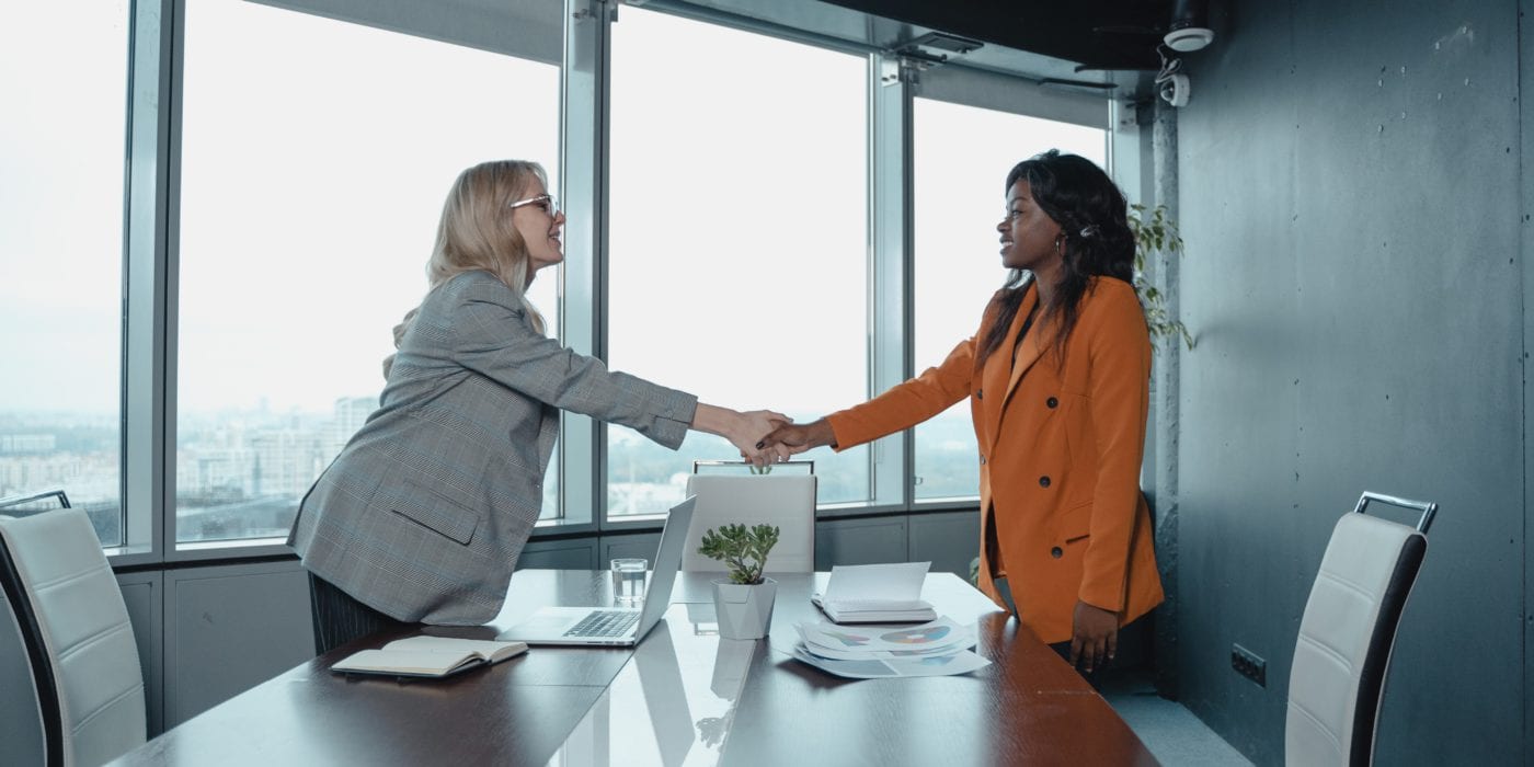 Two businesswomen shaking hands